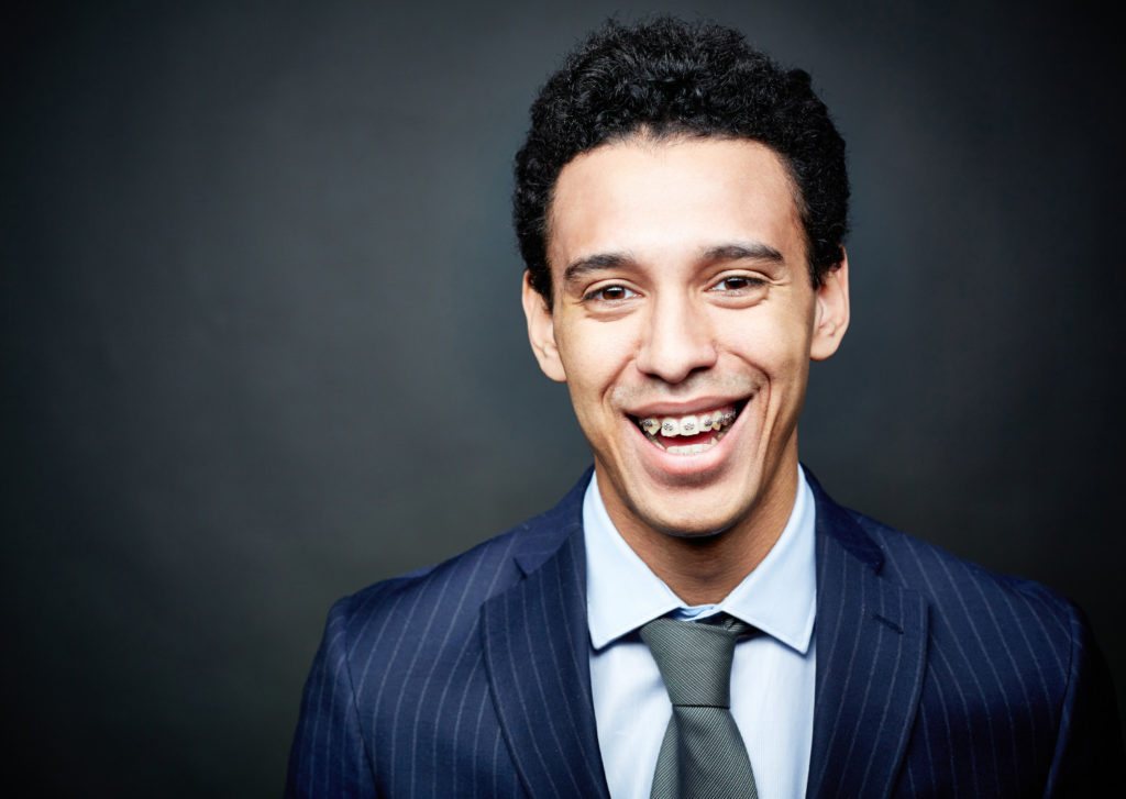 Young man in suit with braces